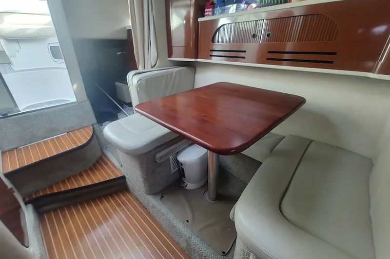 Slide: The Image of Interior of 2009 Sea Ray Sundancer 280 with wooden table and seating area. - 28