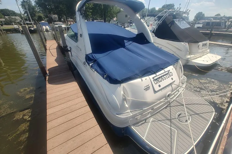 Slide: The Image of 2008 Sea Ray Sundancer 280 docked, featuring blue cover and sleek design. - 4