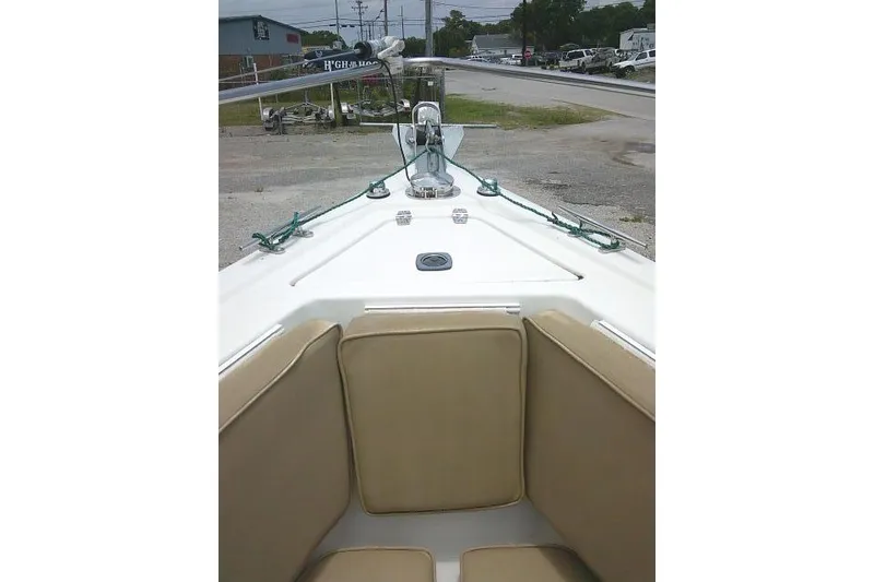 Slide: The Image of 2008 C-Dory 22' Angler boat interior with beige seating and deck view. - 9