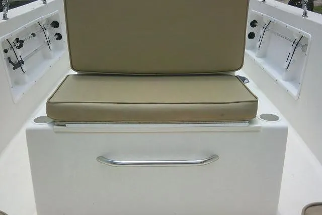 Slide: The Image of 2008 C-Dory 22' Angler boat seat with beige cushions and storage compartments. - 10