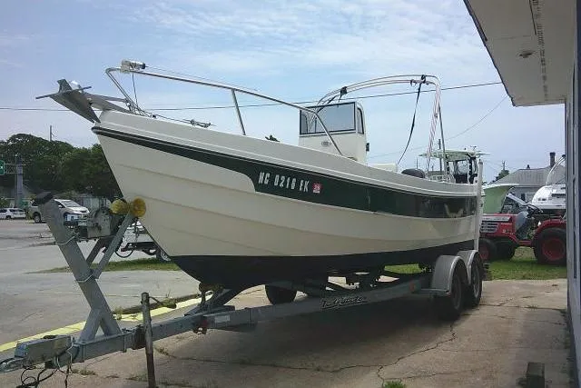 Slide: The Image of 2008 C-Dory 22' Angler boat on trailer, parked outdoors near a building. - 5