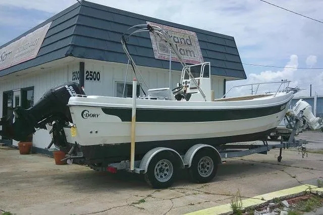 Slide: The Image of 2008 C-Dory 22' Angler boat on trailer outside a building. - 2