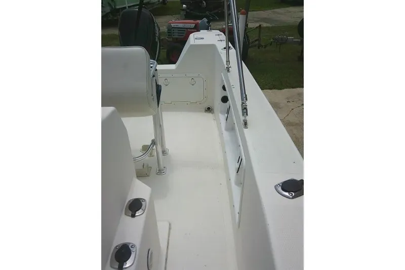 Slide: The Image of 2008 C-Dory 22' Angler boat interior, showcasing seating and storage compartments. - 12