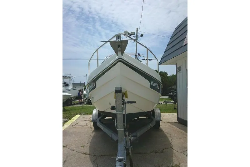 Slide: The Image of 2008 C-Dory 22' Angler boat on trailer, parked outdoors under a cloudy sky. - 6
