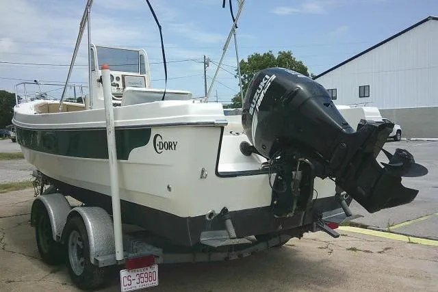 Slide: The Image of 2008 C-Dory 22' Angler boat on trailer with outboard motor in parking lot. - 4