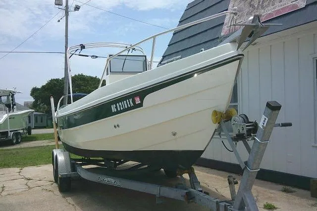 Slide: The Image of 2008 C-Dory 22' Angler boat on trailer, parked beside a building. - 7