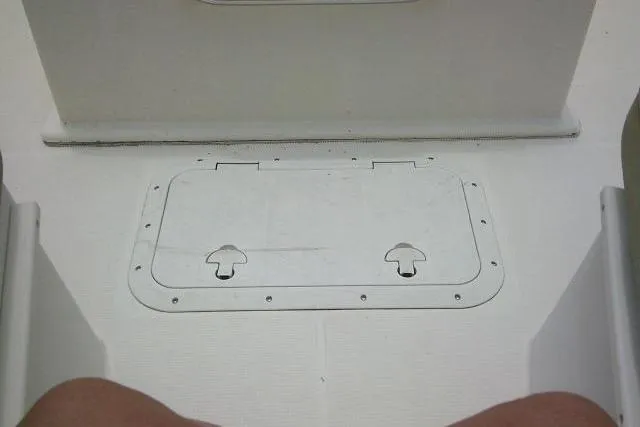 Slide: The Image of 2008 C-Dory 22' Angler boat deck hatch, white surface with secure latches. - 11