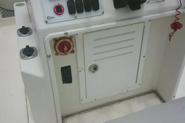 Slide: The Image of Control panel of a 2008 C-Dory 22' Angler boat, featuring switches and a storage compartment. - 26