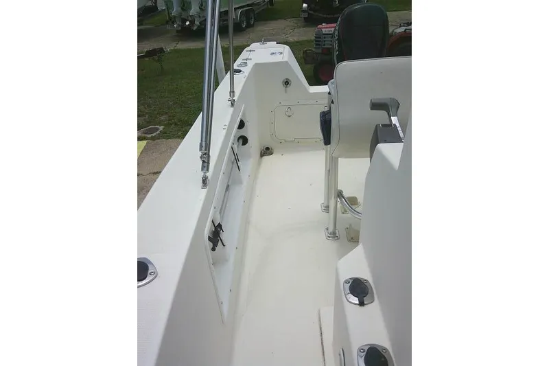 Slide: The Image of 2008 C-Dory 22' Angler boat interior, featuring seating and storage compartments. - 13