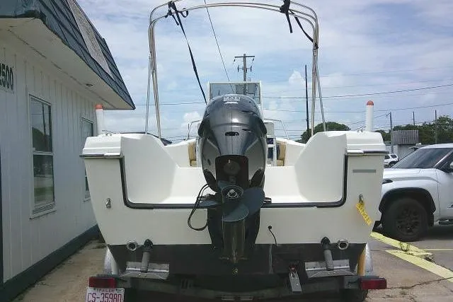 Slide: The Image of 2008 C-Dory 22' Angler boat with outboard motor, parked outdoors. - 3