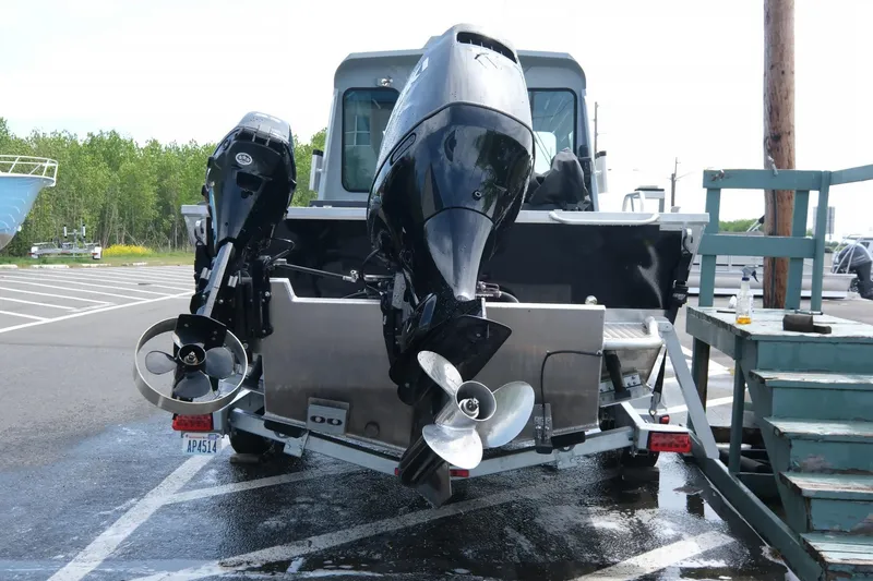 Slide: The Image of 2022 Hewescraft 210 Sea Runner ET Hardtop with dual outboard motors in a parking lot. - 11