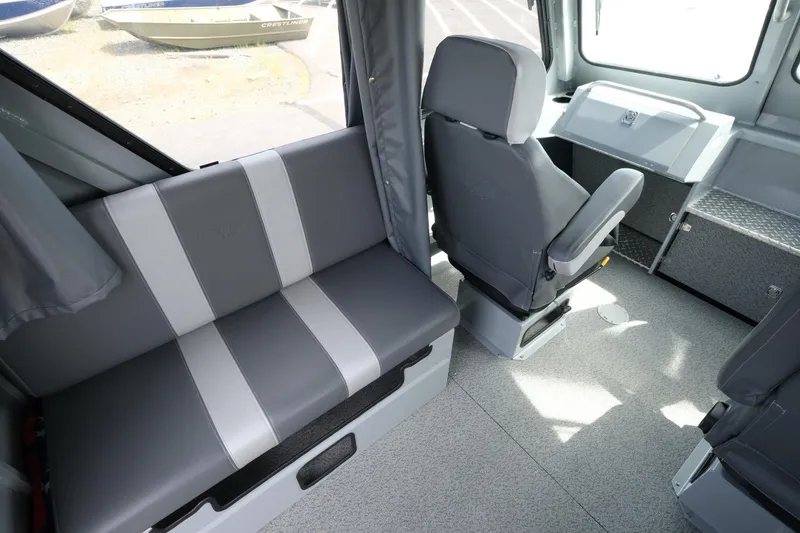 Slide: The Image of Interior of 2022 Hewescraft 210 Sea Runner ET Hardtop, featuring gray seating and helm area. - 17