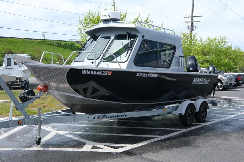 The Image of 2022 Hewescraft 210 Sea Runner ET Hardtop boat on trailer in parking lot. - 7