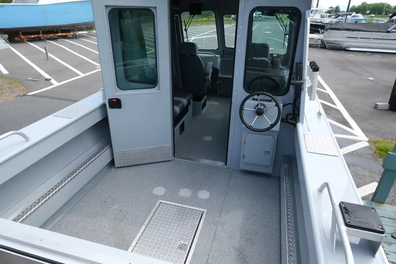 Slide: The Image of 2022 Hewescraft 210 Sea Runner ET Hardtop boat interior with steering wheel and seating. - 12