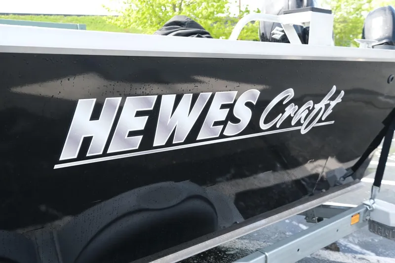 Slide: The Image of 2022 Hewescraft 210 Sea Runner ET Hardtop boat with logo on black hull. - 27