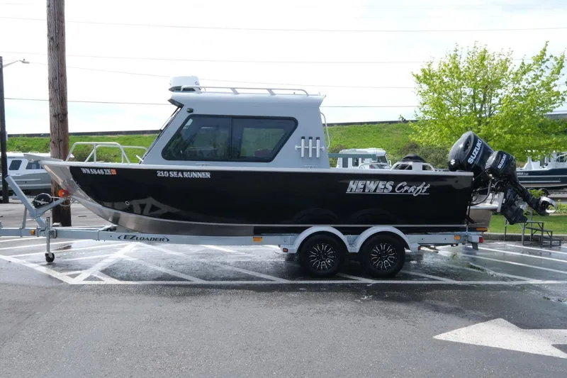 Slide: The Image of 2022 Hewescraft 210 Sea Runner ET Hardtop boat on trailer in parking lot. - 8
