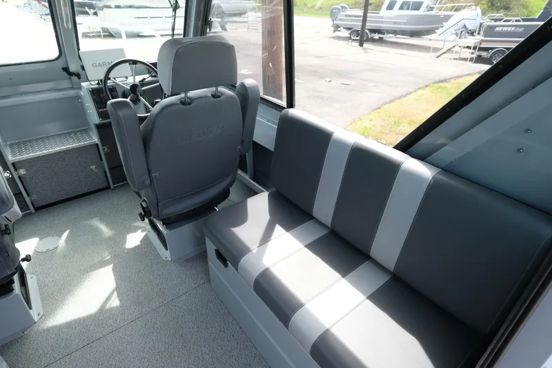 Slide: The Image of Interior of 2022 Hewescraft 210 Sea Runner ET Hardtop, featuring seating and helm area. - 18