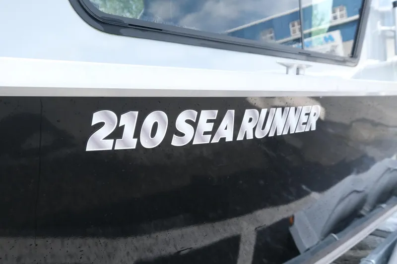 Slide: The Image of 2022 Hewescraft 210 Sea Runner ET Hardtop boat exterior with model name displayed. - 15