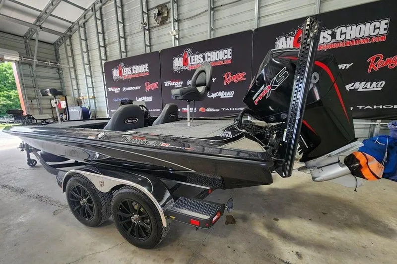 Slide: The Image of 2026 Triton 20XP fishing boat in a showroom, featuring sleek design and powerful engine. - 4