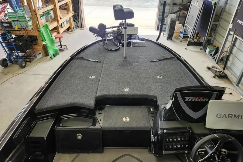 Slide: The Image of 2026 Triton 20XP boat interior with Garmin electronics in a garage setting. - 10