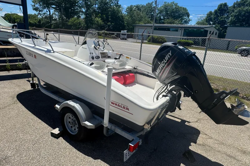 Slide: The Image of 2014 Boston Whaler 150 Super Sport boat on trailer with Mercury outboard motor. - 4