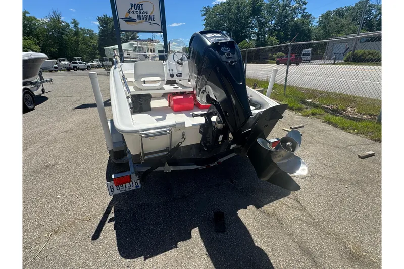 Slide: The Image of 2014 Boston Whaler 150 Super Sport boat with outboard motor at Port Harbor Marine. - 11