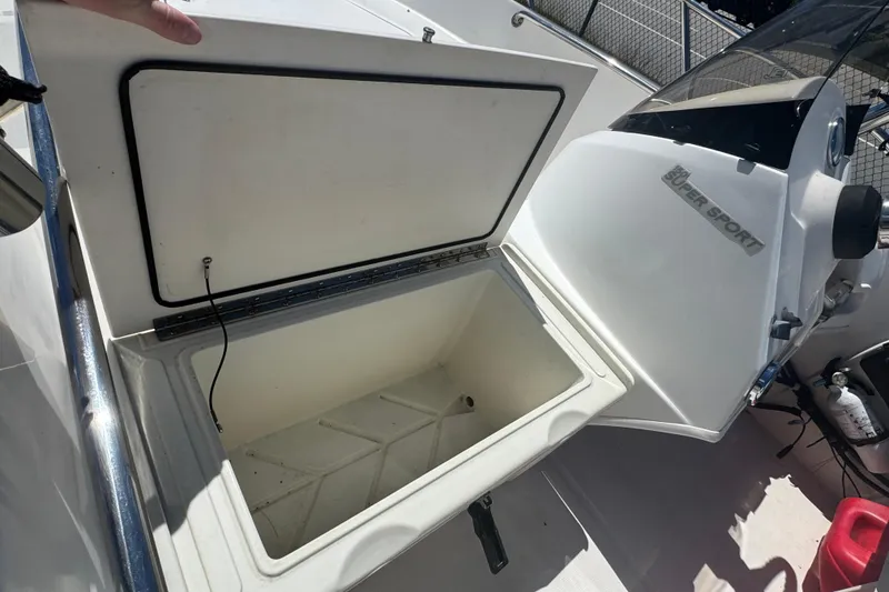 Slide: The Image of Open storage compartment on a 2014 Boston Whaler 150 Super Sport boat. - 8