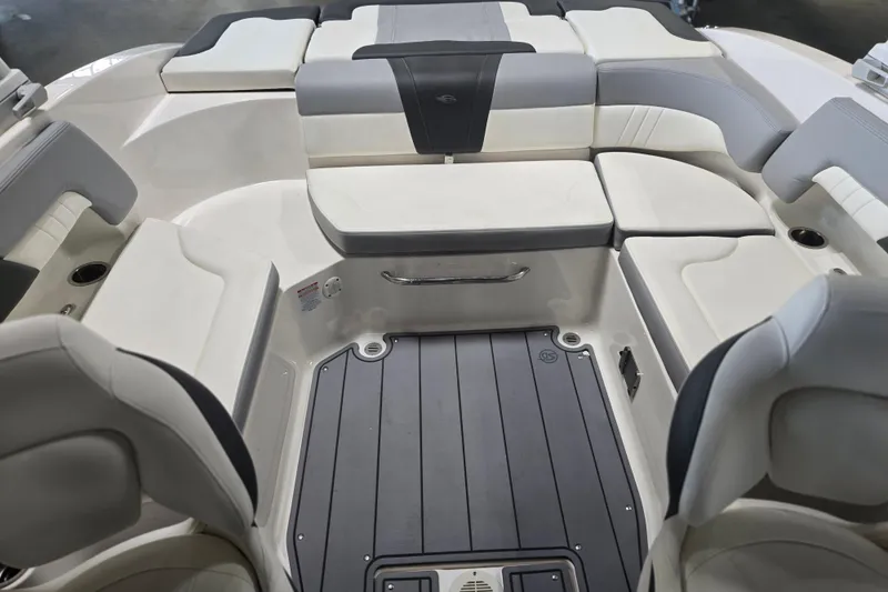 Slide: The Image of 2023 Chaparral 23 SSi boat interior with cushioned seating and sleek design. - 15