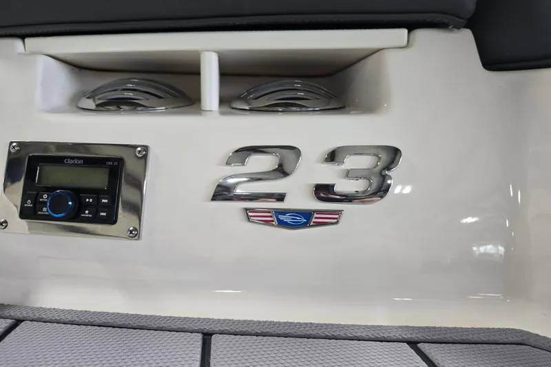 Slide: The Image of 2023 Chaparral 23 SSi boat interior with Clarion audio system and model emblem. - 9