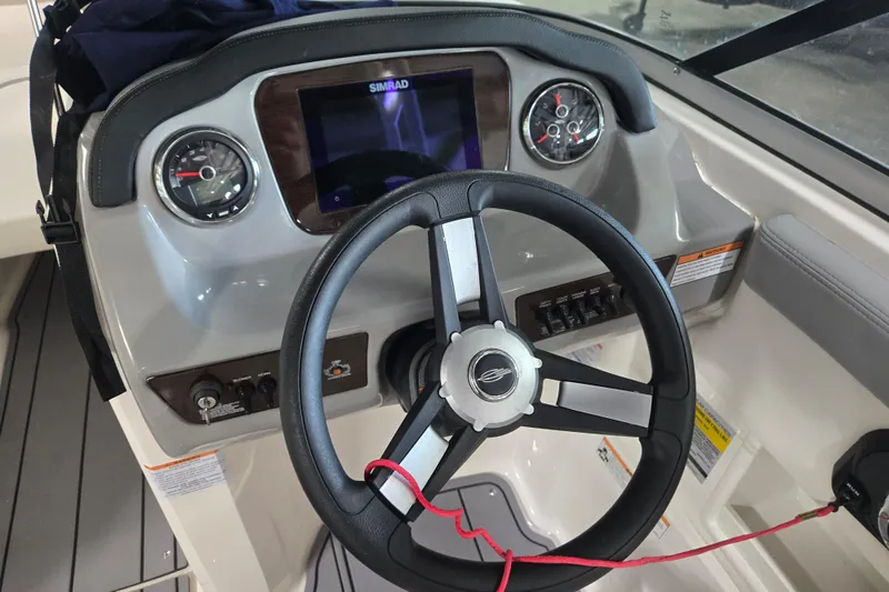 Slide: The Image of 2023 Chaparral 23 SSi boat dashboard with steering wheel and control panel. - 12