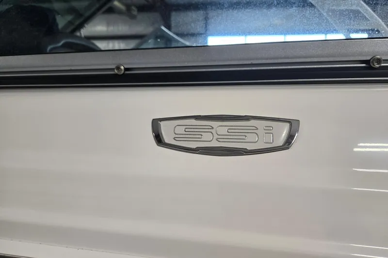 Slide: The Image of 2023 Chaparral 23 SSi boat emblem on white exterior. - 6