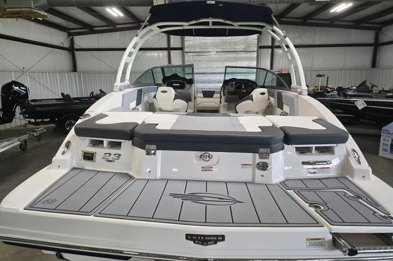 Slide: The Image of 2023 Chaparral 23 SSi boat in showroom, featuring sleek design and spacious seating. - 8
