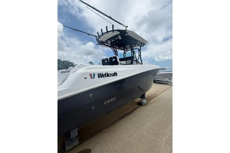 Slide: The Image of 2022 Wellcraft 262 Fisherman boat on display under cloudy sky. - 1