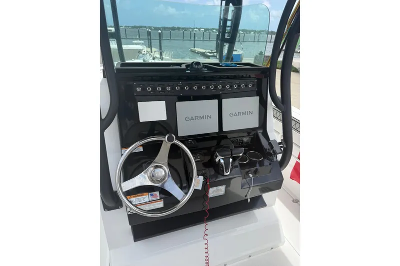 Slide: The Image of 2022 Wellcraft 262 Fisherman helm with dual Garmin displays and steering wheel. - 7