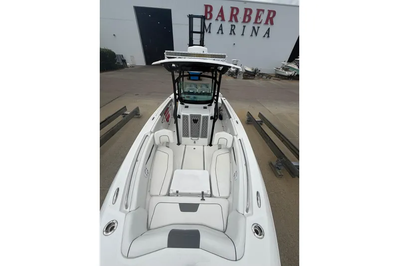 Slide: The Image of 2022 Wellcraft 262 Fisherman boat at Barber Marina, showcasing sleek design and spacious seating. - 2