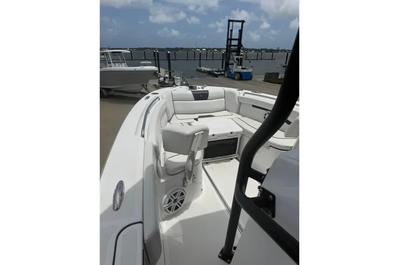 Slide: The Image of 2022 Wellcraft 262 Fisherman boat interior with seating, docked by the water. - 6