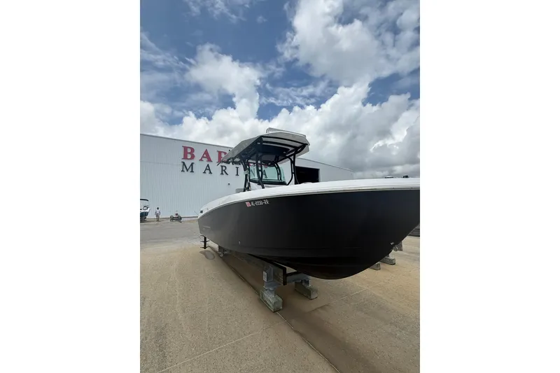 The Image of 2022 Wellcraft 262 Fisherman boat displayed at a marina under a cloudy sky. - 0