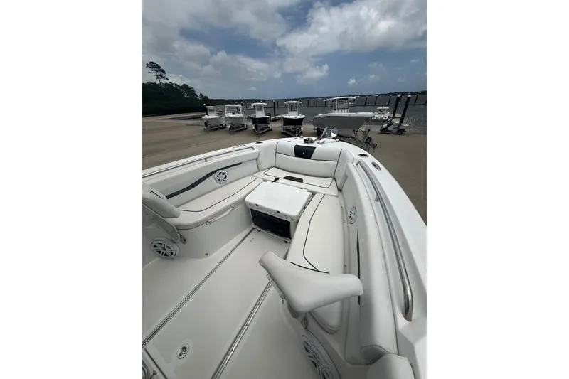 Slide: The Image of 2022 Wellcraft 262 Fisherman boat interior with seating, docked under cloudy sky. - 4