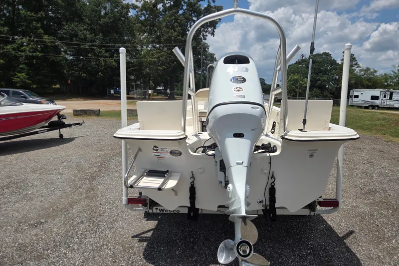 Slide: The Image of 2022 Carolina Skiff 21 LS boat with outboard motor, parked outdoors on gravel. - 7