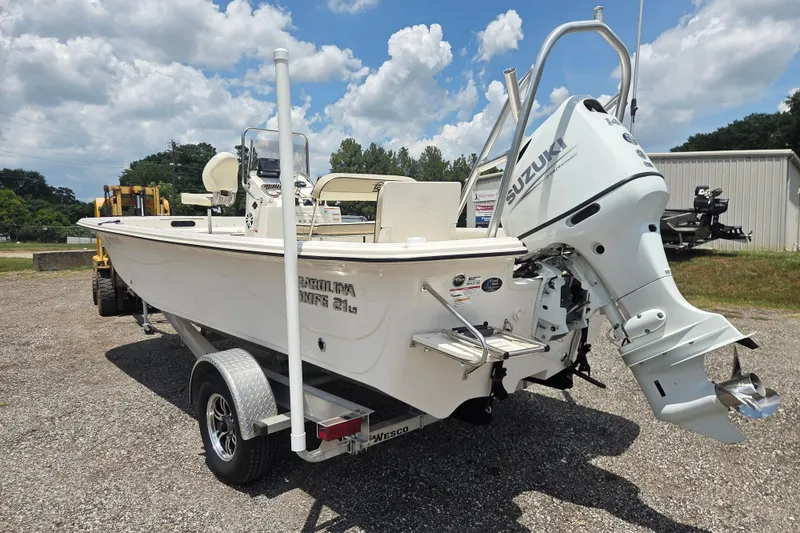 Slide: The Image of 2022 Carolina Skiff 21 LS boat with Suzuki outboard motor on trailer, parked outdoors. - 8