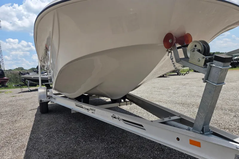 Slide: The Image of 2022 Carolina Skiff 21 LS boat on trailer under a clear blue sky. - 4
