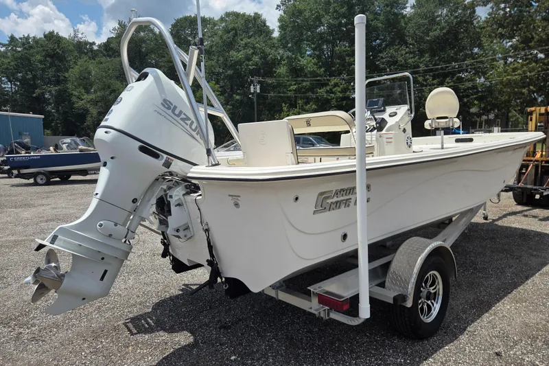 Slide: The Image of 2022 Carolina Skiff 21 LS boat with Suzuki outboard motor on trailer, parked outdoors. - 6