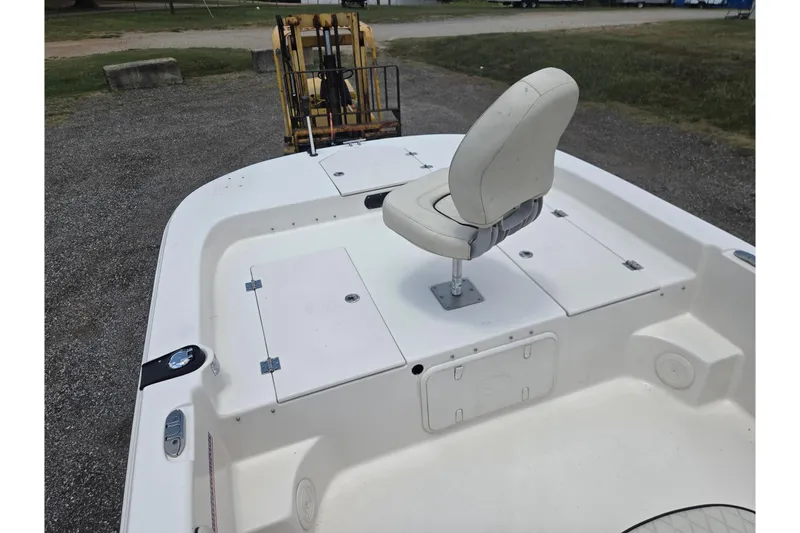 Slide: The Image of 2022 Carolina Skiff 21 LS boat with white seating and storage compartments. - 16