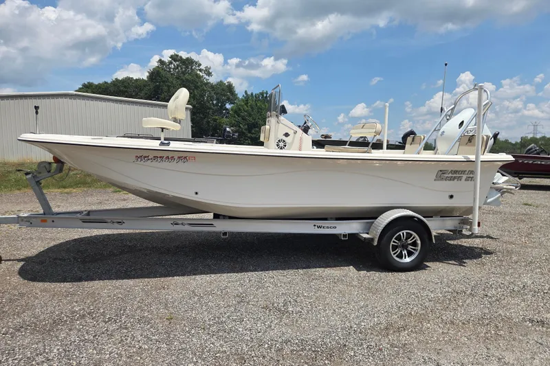 The Image of 2022 Carolina Skiff 21 LS boat on trailer under a partly cloudy sky. - 1