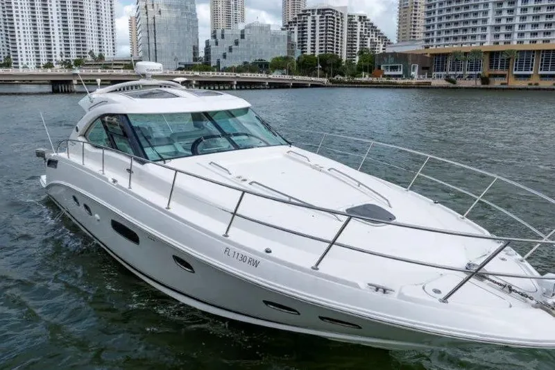 Slide: The Image of 2009 Sea Ray 43 Sundancer yacht cruising in urban waterfront setting. - 2