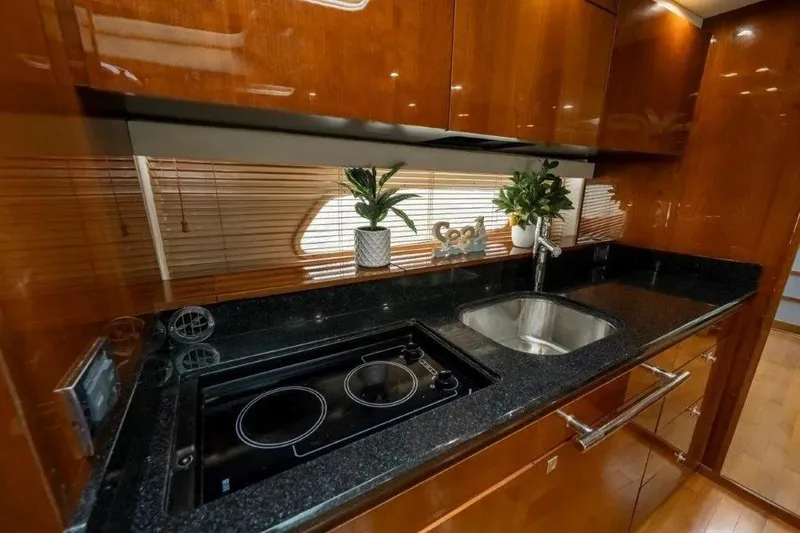 Slide: The Image of Luxurious kitchen interior of 2009 Sea Ray 43 Sundancer yacht with sleek countertops. - 21