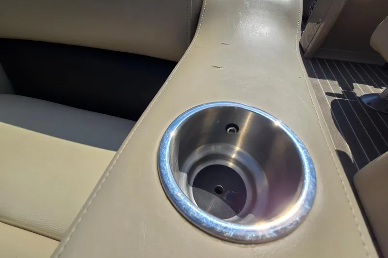 Slide: The Image of Cup holder on 2016 Manitou 23 Oasis SR boat with beige upholstery. - 40