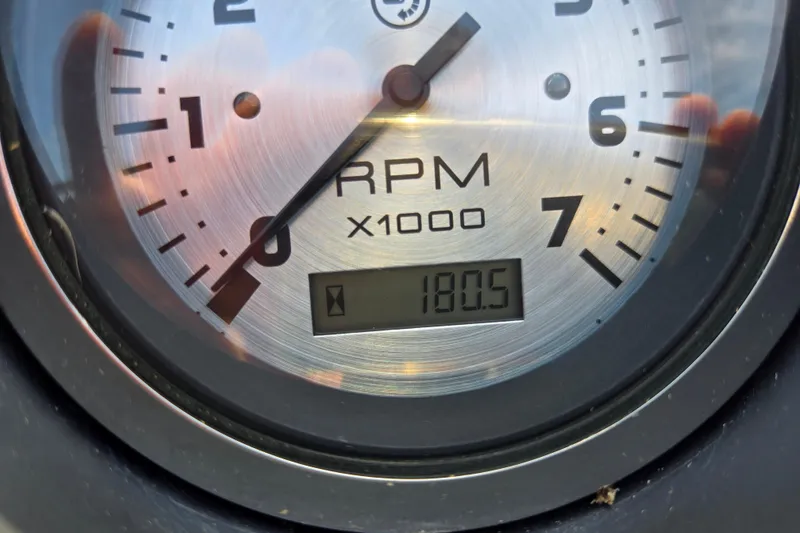 Slide: The Image of Close-up of a 2016 Manitou 23 Oasis SR tachometer showing 180.5 RPM. - 47