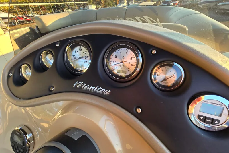 Slide: The Image of Dashboard of 2016 Manitou 23 Oasis SR boat with gauges and controls. - 28