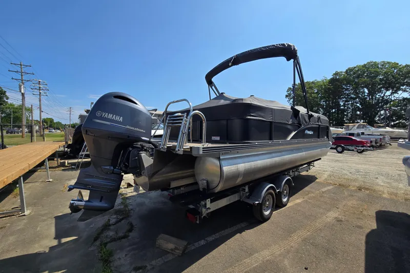Slide: The Image of 2016 Manitou 23 Oasis SR pontoon boat with Yamaha engine on trailer. - 6